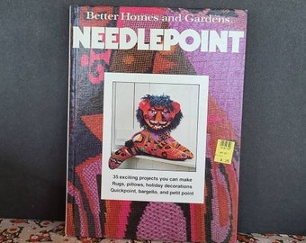 May include: A book titled "Better Homes and Gardens Needlepoint" featuring a colourful needlepoint lion on the cover. The book includes 35 exciting projects you can make, such as rugs, cushions, festive decorations, and more. It teaches quickpoint, bargello, and petit point techniques.