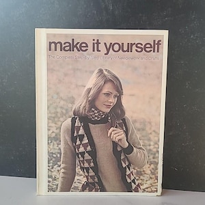 May include: A book titled "make it yourself" with the subtitle "The Complete Step-by-Step Library of Needlework and Crafts". The cover features a woman wearing a brown sweater and a patterned scarf.