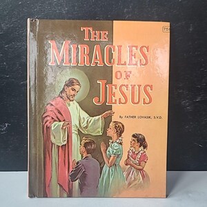 May include: Vintage book titled "The Miracles of Jesus" with an illustration of Jesus and children. The cover is divided into brown and orange sections with the title in large, red letters. The book is a religious item.