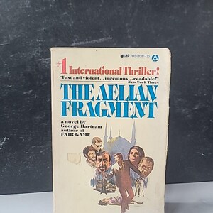 May include: Vintage paperback book titled "The Aelian Fragment" by George Bartram. The cover features a blue and white title, a graphic of people, and the text "International Thriller". The book is in good condition.