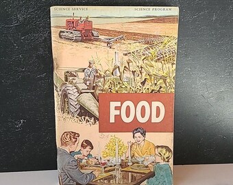 May include: A vintage book cover with the title "FOOD" in red letters. The cover features illustrations of a red tractor plowing a field, a farmer driving a tractor through a cornfield, and a family sitting at a table eating a meal.