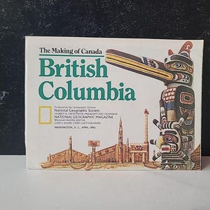 May include: A book titled "The Making of Canada: British Columbia" with a colorful illustration of a totem pole and buildings. The cover features text in green and white, with the National Geographic Society logo.