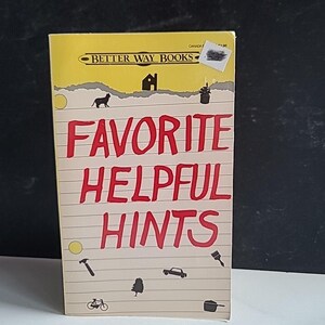 May include: A yellow book with the title "Favorite Helpful Hints" in red text. The book is from Better Way Books and has illustrations of a house, a cat, a plant, a hammer, a tree, a car, a bicycle, and a pot.