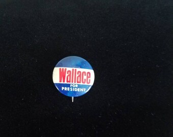May include: A blue, white, and red political campaign button with the text "Wallace for President".