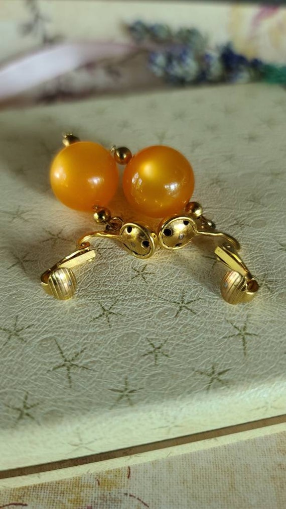 Celebrity Orange Dangling Clip-on Earrings - image 9