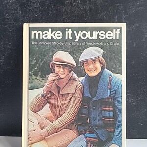 May include: A book titled "make it yourself" with a subtitle "The Complete Step-by-Step Library of Needlework and Crafts". The cover features a photo of two people wearing knitted sweaters and hats.