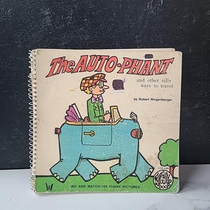 May include: A vintage spiral-bound book titled "The AUTO-PHANT" with a cartoon illustration of a person driving a blue elephant-shaped vehicle. The book cover also features the text "and other silly ways to travel" and "MIX AND MATCH 100 FUNNY PICTURES!"