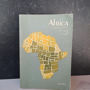 May include: A book titled "Africa in Perspective" with a map of Africa on the cover. The cover is a muted green color with the title in white and the map in shades of yellow and green. The book is by F. Seth Singleton and John Shingler.
