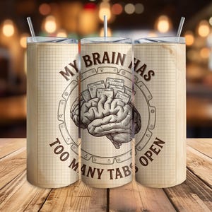 May include: A beige stainless steel tumbler with a straw, featuring a vintage-style design. The design includes a detailed illustration of a brain with multiple open tabs, and the text "MY BRAIN HAS TOO MANY TABS OPEN" in a circular layout.