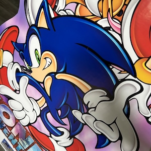 May include: A blue and white cartoon character with green eyes and a red shoe. The character is running and has a white glove on one hand. The background is purple and pink.