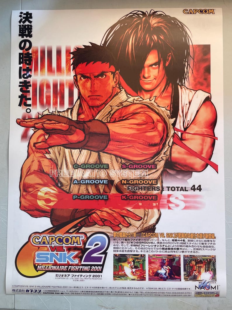 May include: A poster for the arcade fighting game Capcom vs. SNK 2: Millionaire Fighting 2001. The poster features two characters, Ryu from Street Fighter and Kyo Kusanagi from The King of Fighters, in a fighting pose. The poster is red, white, and black with the game's title in large, bold letters. The poster also includes the text "Free Ratio System" and "Total 44 Fighters".