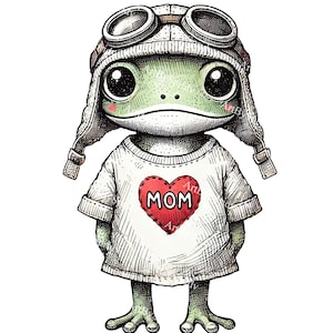 May include: A green frog wearing a white shirt with a red heart that says "MOM" on it. The frog is also wearing a brown aviator hat with goggles.
