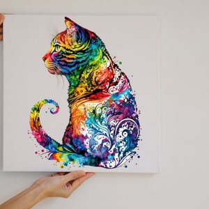May include: A colorful abstract painting of a cat sitting with its tail curled around its body. The cat is painted in a variety of bright colors, including red, orange, yellow, green, blue, and purple. The background is white.