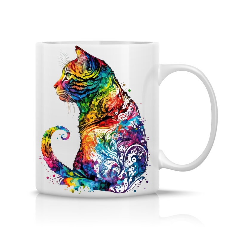 May include: White ceramic mug with a colorful illustration of a cat sitting with its tail curled around its body. The cat is painted in a rainbow of colors with intricate floral designs.
