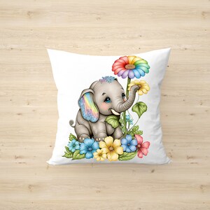 May include: A white pillow with a gray elephant with rainbow ears and a rainbow flower. The elephant is surrounded by colorful flowers and green leaves.