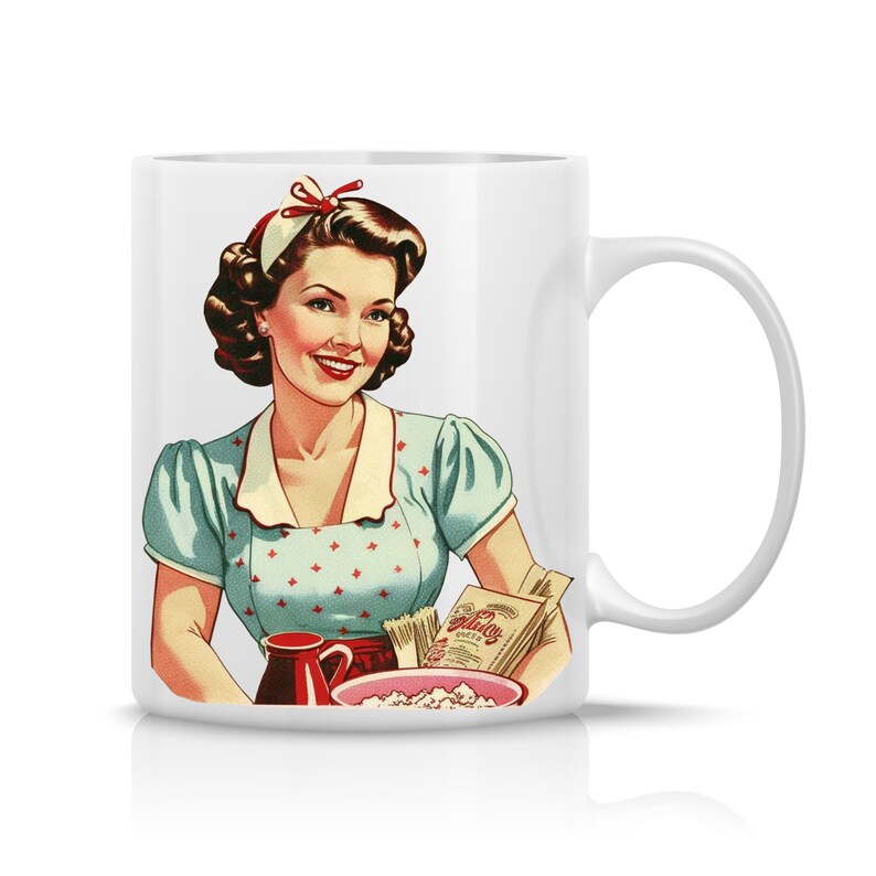 May include: White ceramic mug with a vintage illustration of a woman in a blue and white polka dot dress holding a bowl of popcorn. The woman is wearing a red headband and has a smile on her face. The mug has a handle on the right side.