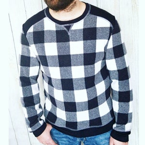May include: A black and white checkered long-sleeve shirt with a crew neck.
