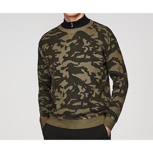May include: A green and black camouflage print sweatshirt with a round neckline and long sleeves.