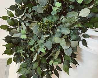 May include: A lush green garland made of eucalyptus and other greenery, perfect for adding a touch of nature to your wedding or event decor.