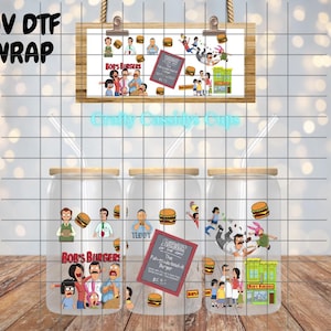 May include: Clear glass beverage cups with lids and straws, featuring a colorful cartoon design. The design includes characters and elements from the animated show "Bob's Burgers", with the show's logo and burger illustrations. The text "Bob's Burgers" is visible.
