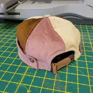 May include: A white ceramic mug with a black handle and the text "But First, Coffee" in a bold, black font. The mug is set against a neutral background, highlighting its simple design.