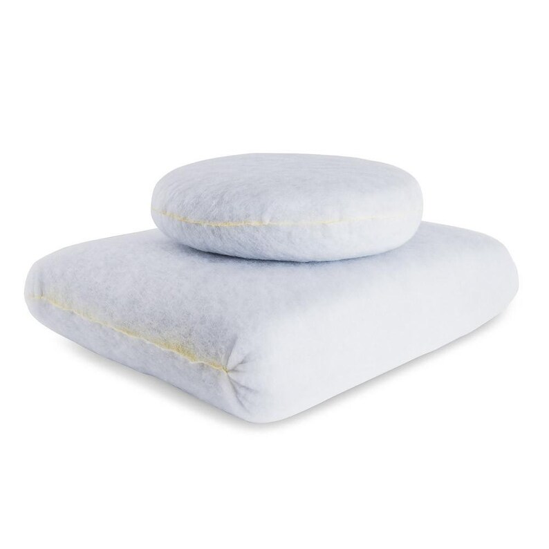 May include: Two light blue, plush, round cushions. The smaller cushion is on top of the larger cushion.