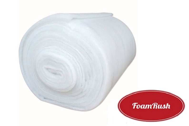 May include: A white roll of polyester batting, a soft, fluffy material used for quilting, crafts, and upholstery. The roll is tightly wound and has a smooth, even surface. The brand name "FoamRush" is printed in red on a white oval.