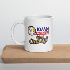May include: White ceramic mug with a blue and yellow logo that says "4 KWWN SAN DIEGO Stay Classy!"