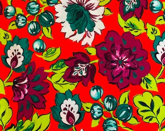 100% Cotton print floral fabric in shades of magenta, chartreuse, tropical green, etc on an orange background; for apparel and quilting