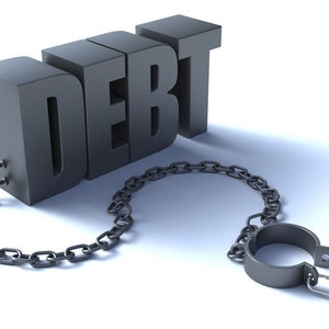 May include: The word "DEBT" is made of metal and is attached to a metal chain and padlock. The chain is looped around the word "DEBT".