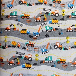 May include: A white background with a repeating pattern of construction vehicles, including excavators, dump trucks, cement mixers, and tractors. The vehicles are in various colors, including orange, yellow, blue, and green. The background is a light gray with yellow dashed lines and gray concrete blocks. The text "VROOOOOM" and "BEEP BEEP" is repeated throughout the pattern.