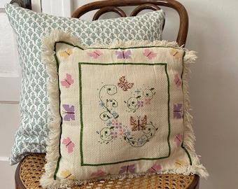 A Vintage Cross-stitch Pillow with Butterfly design.