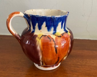 A Small Mexican orange and Blue Glazed Ceramic Pitcher