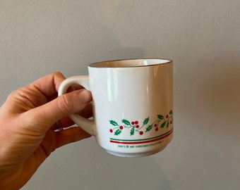 A Pair of Christmas Coffee Mugs with Holly Design