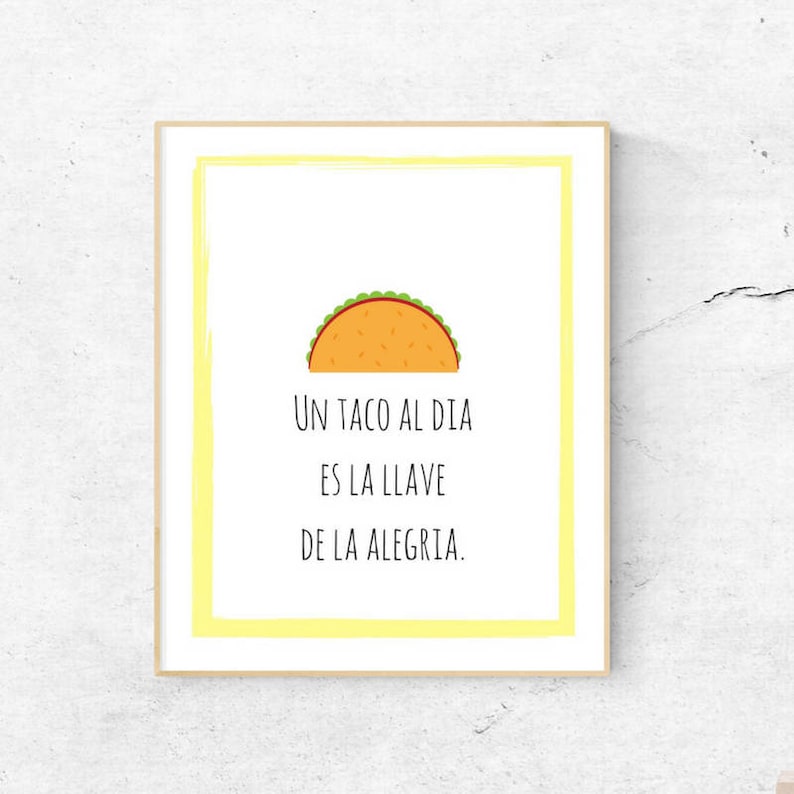 May include: A yellow framed print with a cartoon taco and the text "Un taco al dia es la llave de la alegria."