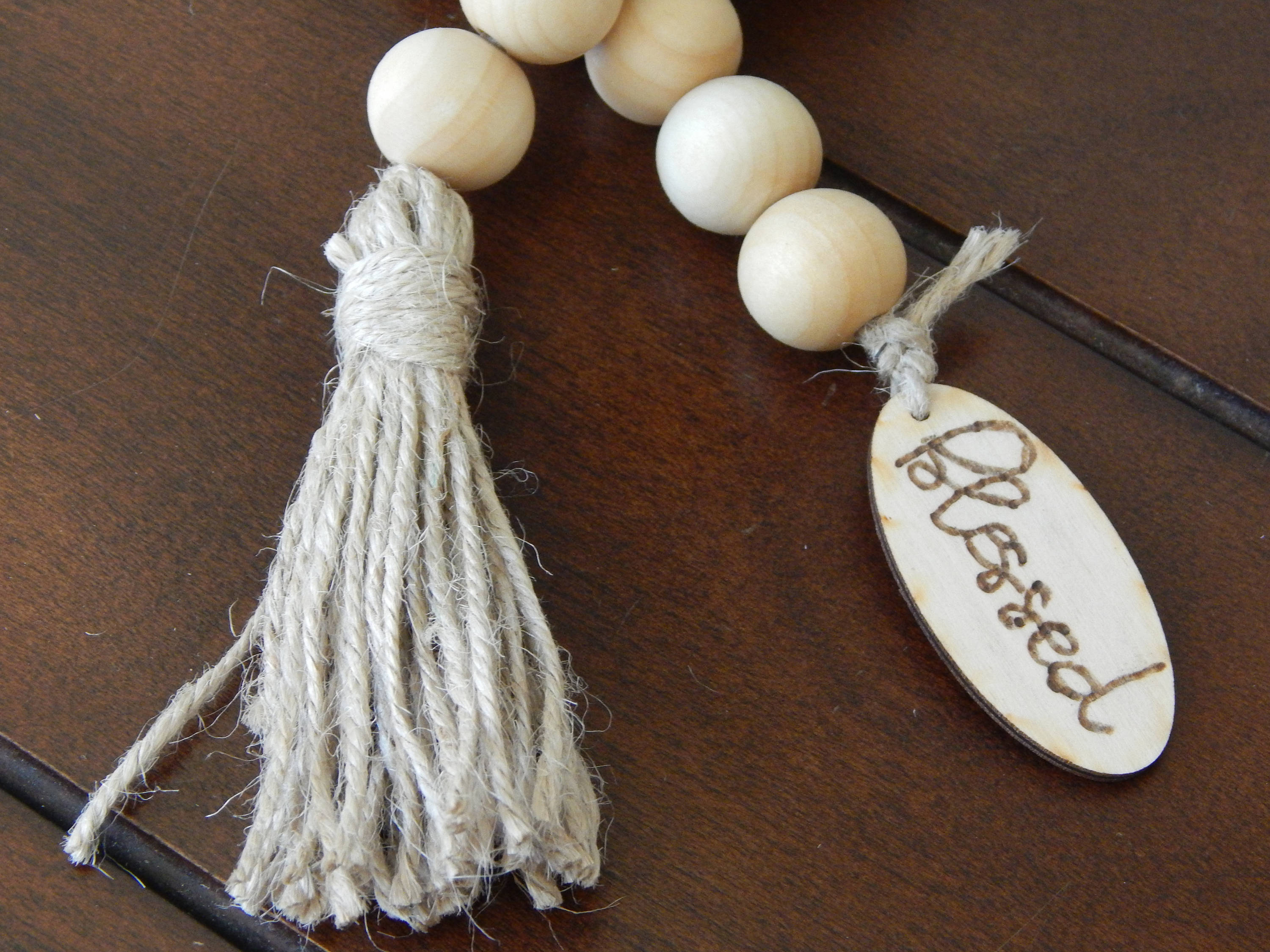 Natural wood bead garland with wood tag and jute tassel, boho home