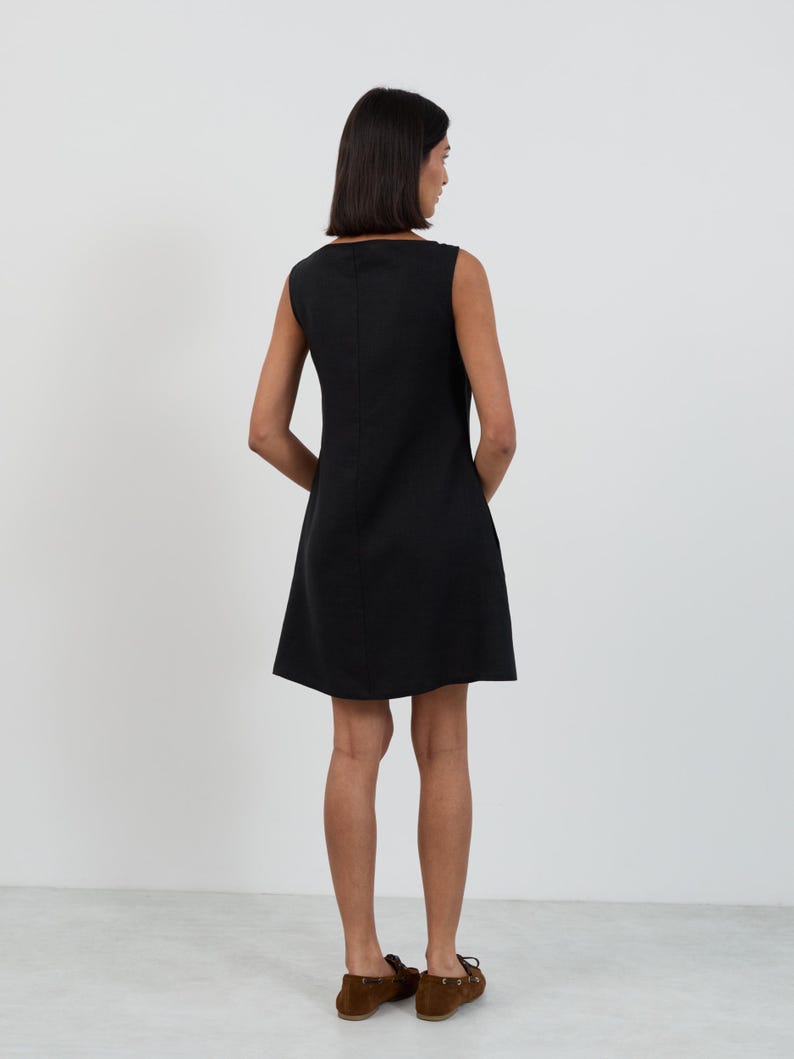 Full-length back view of the CECILIA Black linen mini dress showing the center back seam and clean A-line shape