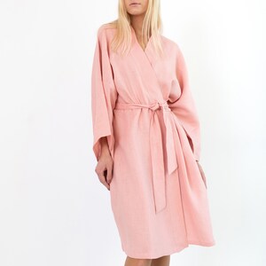 LUNA pink linen kimono robe, front view with hands in the side pockets.