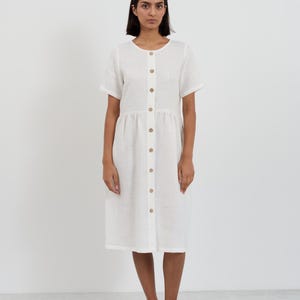Full-length front view of the DOVE Ivory linen midi dress showing the complete button-front closure from neckline to hem with wooden buttons