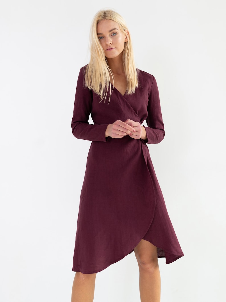 Pu&ograve; includere: Un abito avvolgente color bordeaux con maniche lunghe e scollo a V. L'abito &egrave; realizzato in un tessuto morbido e fluido e ha una silhouette a trapezio lusinghiera.