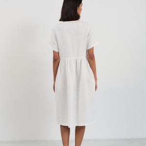 Full-length back view of the DOVE Ivory linen midi dress showing the clean back panel, waist gathering, and straight hemline