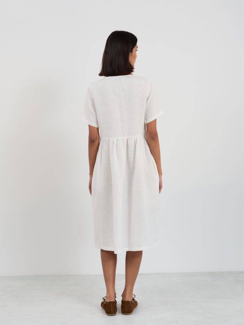 Full-length back view of the DOVE Ivory linen midi dress showing the clean back panel, waist gathering, and straight hemline