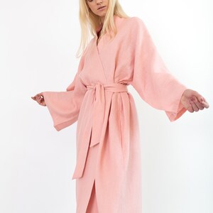 LUNA pink linen kimono robe, angled view with arms extended showing the sleeve width.