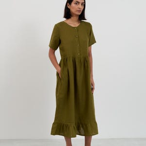 Front view of the SAGE Moss Green linen midi dress showing the full silhouette from neckline through gathered skirt to ruffle hemline