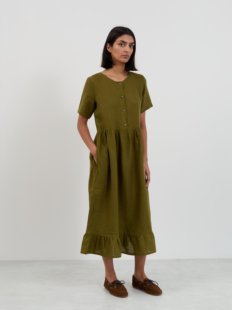 Front view of the SAGE Moss Green linen midi dress showing the full silhouette from neckline through gathered skirt to ruffle hemline