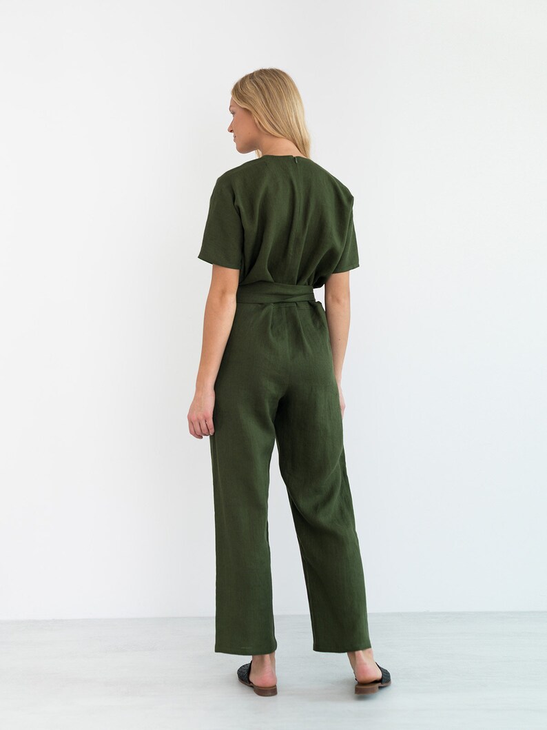 May include: A green linen jumpsuit with a self-tie belt and short sleeves.