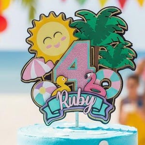 May include: A two-tiered birthday cake with blue and yellow frosting, decorated with beach-themed elements. The cake topper features a sun, palm trees, and the number 4 with the name "Ruby". Miniature figures of children are on the cake.