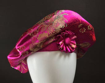 Pink Beret with cockade. Made of hot pink satin brocade. Accented with pleated cockade.