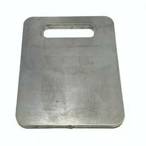 May include: A silver metal plate with a cut-out handle. The plate is rectangular with rounded corners.