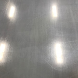 May include: A close-up of a smooth, metallic surface with four bright, white light reflections.